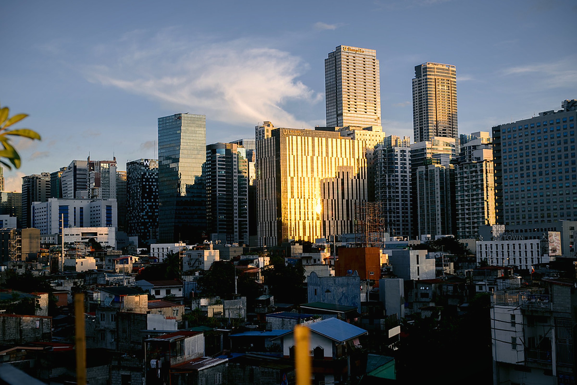Manila skyline at golden hour, Makati towers catching the last light